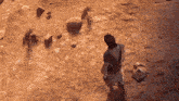 a man in a white robe is standing in a desert