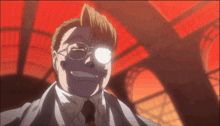 a man in a suit and tie is smiling with a red background behind him