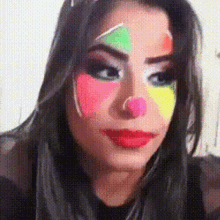 a woman with clown makeup on her face looks at the camera