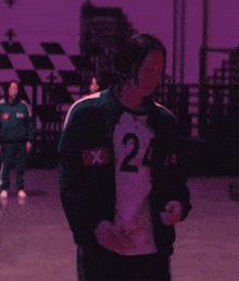 a man in a green jacket with the number 24 on it