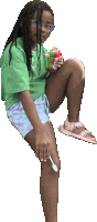 a girl in a green shirt is eating ice cream