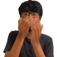 a man with glasses and a black shirt is covering his face with his hands