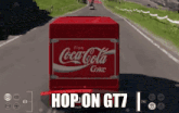 a coca cola van is driving down a road