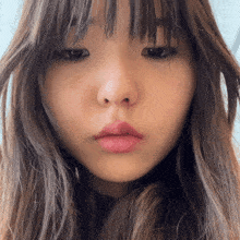 a close up of a woman 's face with a pink lip
