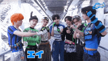 a group of young men are standing next to each other and one of them is wearing a shirt that says e-i-t