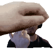 a pixel art of a hand holding a piece of paper over a man 's face .