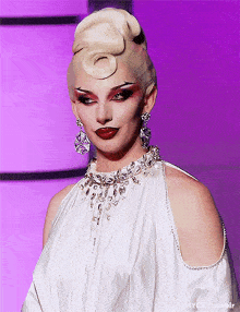 a woman is wearing a white dress and a necklace with a purple background