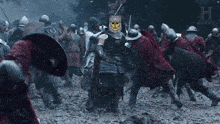 a knight with a skull on his head is surrounded by a crowd of soldiers and the word history is on the bottom right