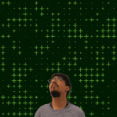 a man with a beard and glasses looks up at the number 22