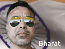 a man wearing sunglasses and the word bharat on the bottom right
