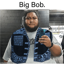 a man with a beard is taking a selfie in front of a mirror with the caption big bob