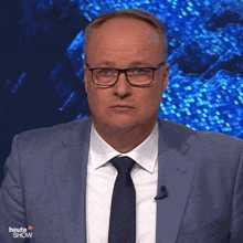 a man wearing glasses and a suit is on a show called heute show