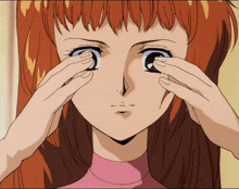 a close up of a woman covering her eyes with her hands