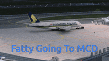 a singapore airlines plane sits on the tarmac