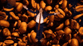 a man in a suit and tie is laying on top of coffee beans