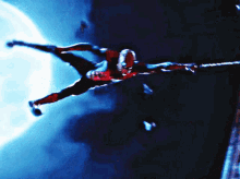 a spider-man is flying through the air with a full moon in the background