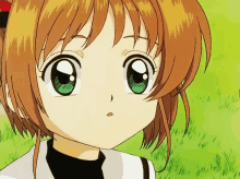 a close up of a girl 's face with green eyes and brown hair