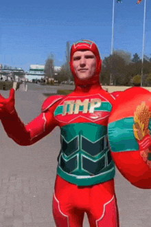 a man in a red and green superhero costume with the word tmp on the chest