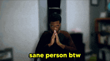 a man with his hands folded and the words sane person btw above him