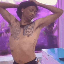 a shirtless man with a tattoo that says not kill fade