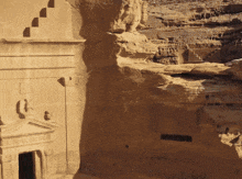 a very old building with a door and stairs on the side