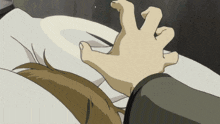 a person laying on a bed with a hand on their face