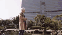 a person standing next to a body of water with imgflip.com written on the bottom