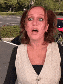 a woman with pigtails and hoop earrings makes a funny face