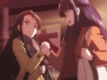 two anime girls are shaking hands in front of a sign that says ' a ' on it