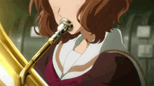 a girl is playing a trombone with a mouthpiece that has a letter p on it