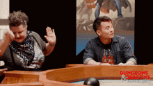 a man and a woman are sitting at a table with the words dungeons & dragons adventures on it