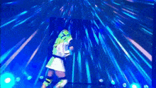 a person in a green and white outfit is dancing on a stage with blue lights behind them