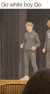 two men are standing on a stage with the words go white boy go written on the bottom