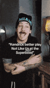 a man wearing a miami hat is talking about kendrick better play not like us at the superbowl