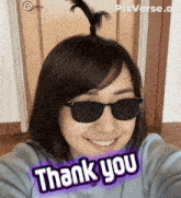 a woman wearing sunglasses says thank you