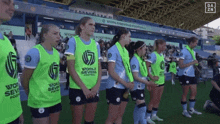 a group of female soccer players wearing world sevens vests