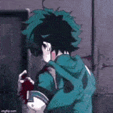 a man with green hair is holding another man 's hand .