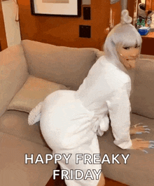 a woman in a white robe is kneeling on a couch and says happy freaky friday .