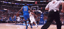 a basketball player in a blue jersey with the number 35 on the back