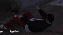 a man is laying on the ground in a dark room with the words ayarlar in the upper right corner