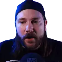 a man with long hair and a beard is wearing a blue hat and a black shirt with the letter r on it