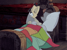 a cartoon cat is sleeping in a bed with a quilt