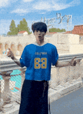 a man wearing a blue rallywag jersey with the number 68 on it