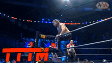 a man in a wrestling ring with omega on his pants