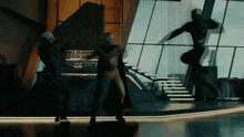a man in a superhero costume is standing in a room with stairs