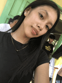 a girl is wearing a black shirt that says become