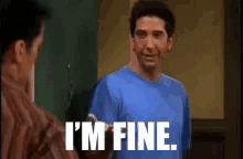 a man in a blue shirt is standing next to a man in a brown shirt and says `` i 'm fine '' .