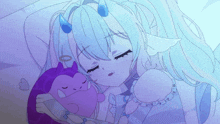 a girl with horns is sleeping next to a purple stuffed animal