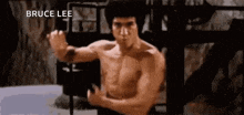 bruce lee is a martial artist without a shirt in a movie .