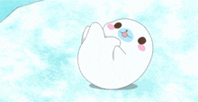 a cartoon drawing of a seal with a blue eye and pink cheeks